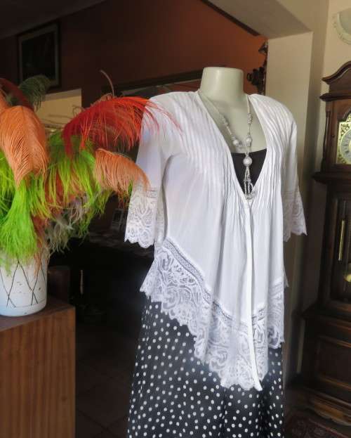 Dainty fine cotton waterfall style white top.Tuckking and lace decoration.One button closure.Size 36
