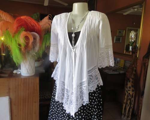 Dainty fine cotton waterfall style white top.Tuckking and lace decoration.One button closure.Size 36