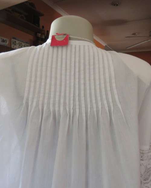 Dainty fine cotton waterfall style white top.Tuckking and lace decoration.One button closure.Size 36