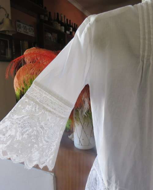 Dainty fine cotton waterfall style white top.Tuckking and lace decoration.One button closure.Size 36