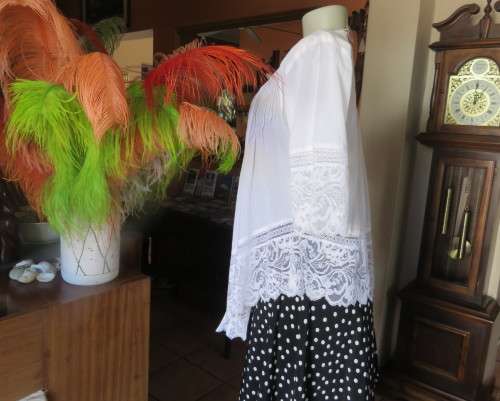 Dainty fine cotton waterfall style white top.Tuckking and lace decoration.One button closure.Size 36