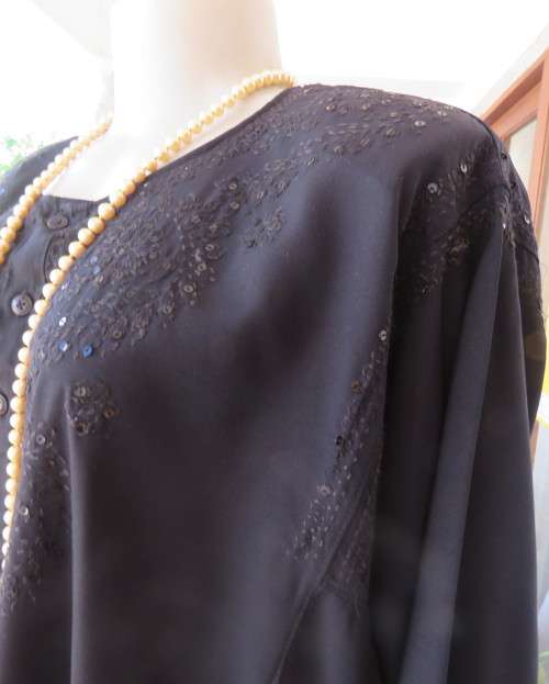 Very black long sleeve slip over 100% rayon richly embroidered/sequined top made in India.Size 46/22