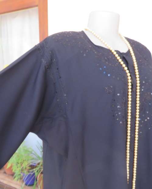 Very black long sleeve slip over 100% rayon richly embroidered/sequined top made in India.Size 46/22