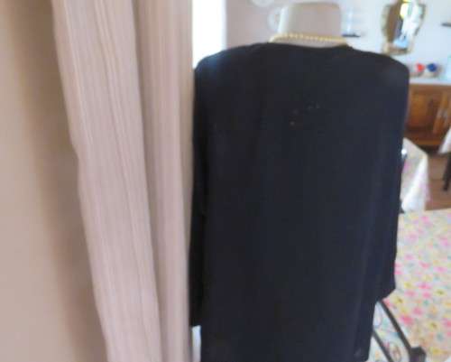 Very black long sleeve slip over 100% rayon richly embroidered/sequined top made in India.Size 46/22
