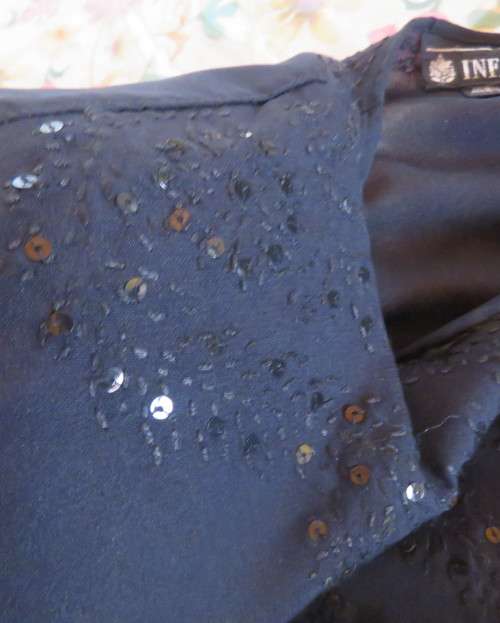 Very black long sleeve slip over 100% rayon richly embroidered/sequined top made in India.Size 46/22