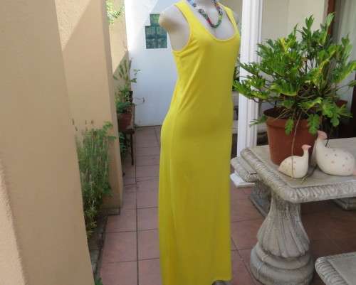As new buttercup yellow maxi sleeveless dress. Scooped neckline.Size 36/12.Polyester/viscose.