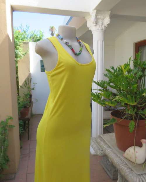 As new buttercup yellow maxi sleeveless dress. Scooped neckline.Size 36/12.Polyester/viscose.