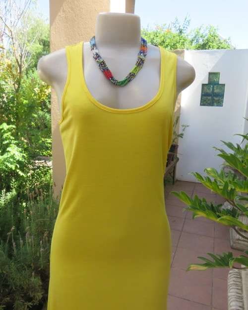 As new buttercup yellow maxi sleeveless dress. Scooped neckline.Size 36/12.Polyester/viscose.