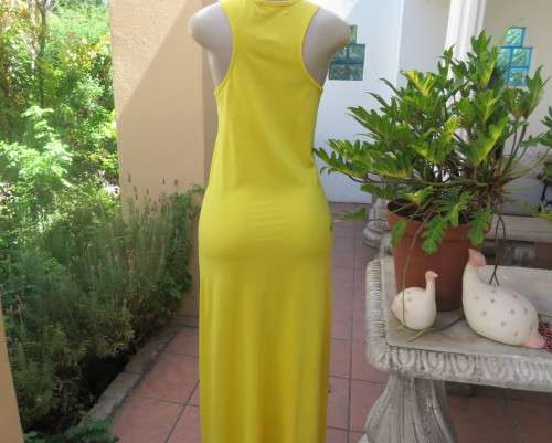 As new buttercup yellow maxi sleeveless dress. Scooped neckline.Size 36/12.Polyester/viscose.