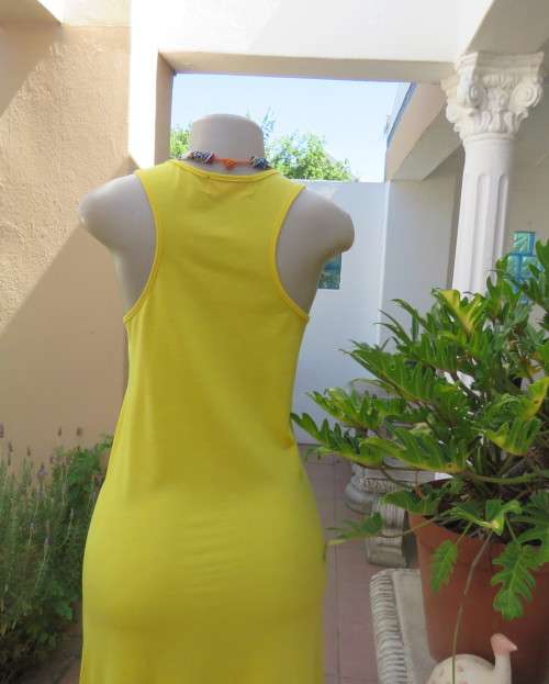 As new buttercup yellow maxi sleeveless dress. Scooped neckline.Size 36/12.Polyester/viscose.