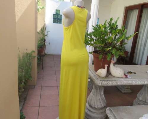As new buttercup yellow maxi sleeveless dress. Scooped neckline.Size 36/12.Polyester/viscose.