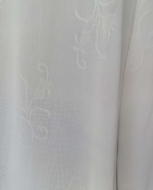 Embossed white loose cut button down V neck top with long sleeves.Size large 40. As new in polyester