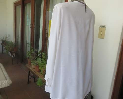 Embossed white loose cut button down V neck top with long sleeves.Size large 40. As new in polyester