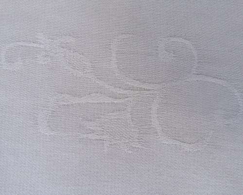 Embossed white loose cut button down V neck top with long sleeves.Size large 40. As new in polyester