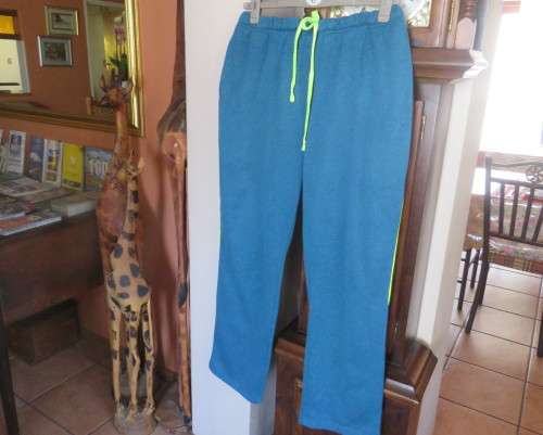 Men`s jade colour brushed polyester sport pants with yellow drawstring and leg edging.By MAXED in L.