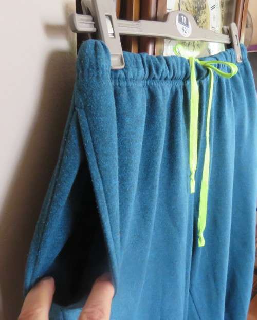 Men`s jade colour brushed polyester sport pants with yellow drawstring and leg edging.By MAXED in L.