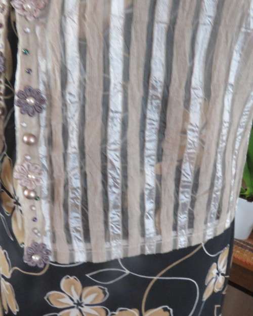 Spice up your outfit with this glamour sleeveless open hanging top.Richly decorated.Size 36.As new.
