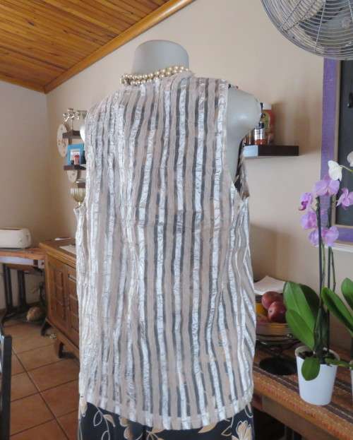 Spice up your outfit with this glamour sleeveless open hanging top.Richly decorated.Size 36.As new.