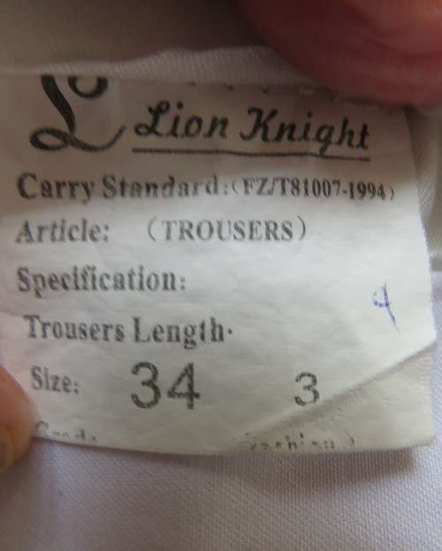 Handsome men`s white trousers by LION KNIGHT size 34 in cotton/terylene and silk.Pleated front.