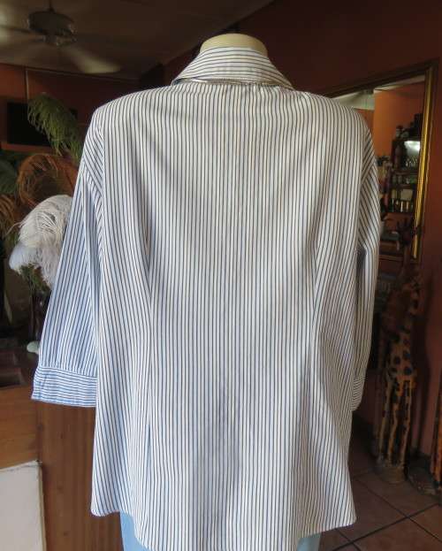 Casual light blue/navy vertical striped button down V neck top with open collar.By PENNY C size 44