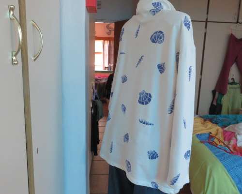 Warm long sleeve white slip over top with blue shells.Zip up front opening and high collar.Size XL