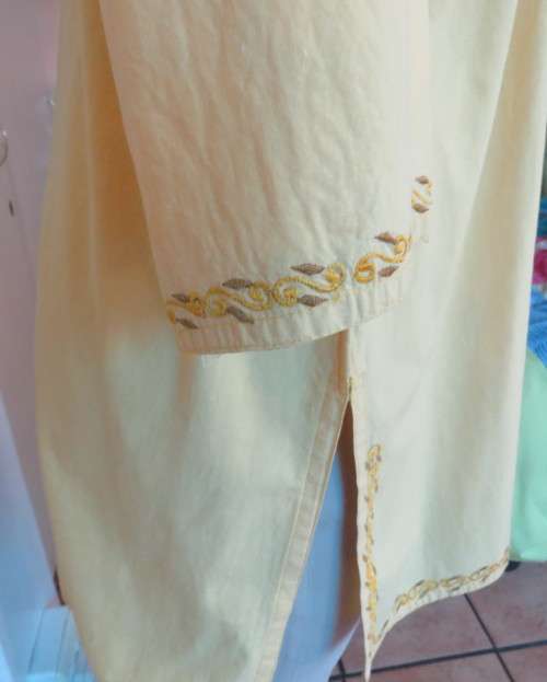 As new buttercup yellow richly embroidered top.Bracelet length sleeves.By BABA forn Kashmi.Size 40
