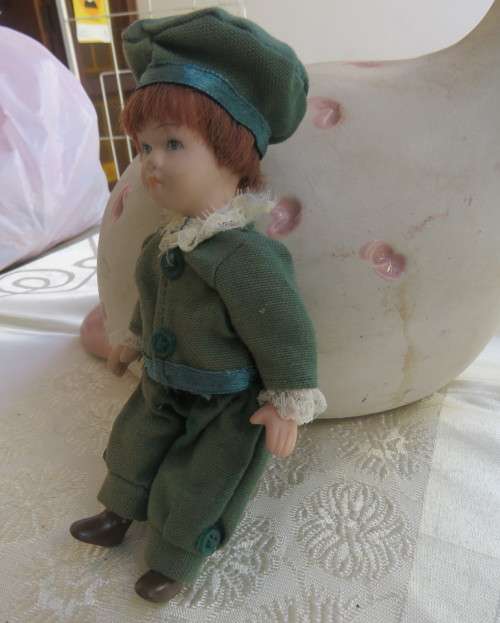 Antique doll 16cm tall with clothing. See all scans. Very good condition