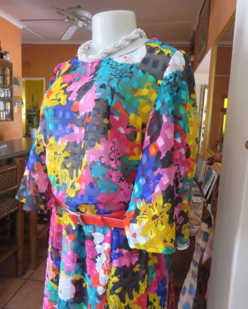 Eye catching vintage sheer polyester dress size 38/14.Bell sleeves.Pleated skirt.Opening at back.