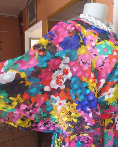 Eye catching vintage sheer polyester dress size 38/14.Bell sleeves.Pleated skirt.Opening at back.