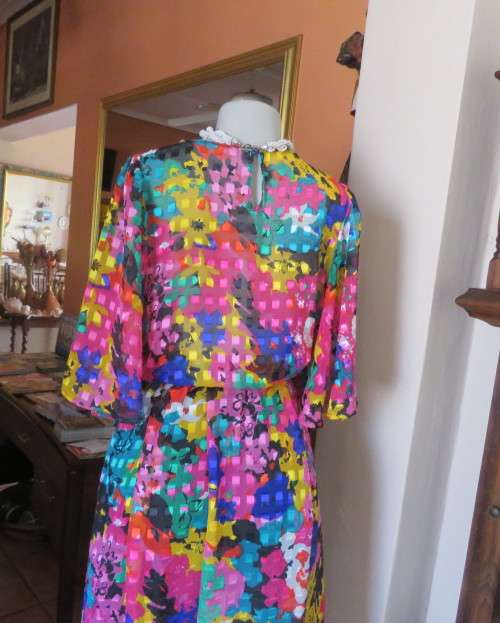 Eye catching vintage sheer polyester dress size 38/14.Bell sleeves.Pleated skirt.Opening at back.