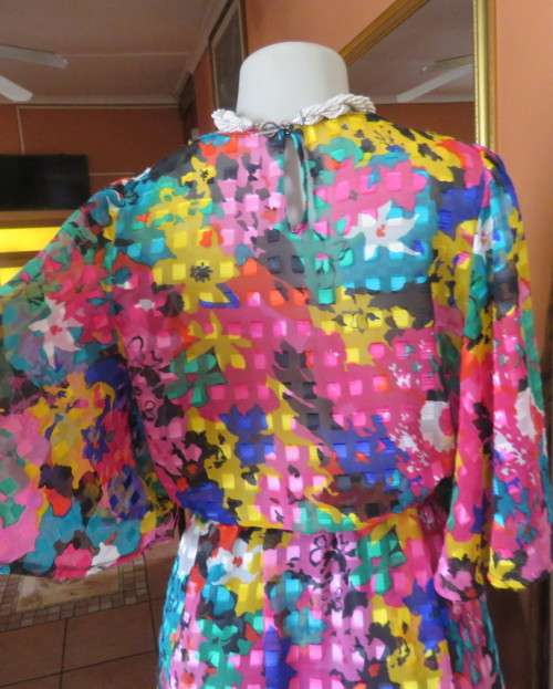 Eye catching vintage sheer polyester dress size 38/14.Bell sleeves.Pleated skirt.Opening at back.