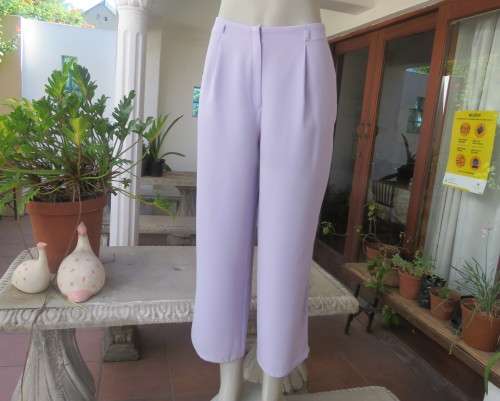 Ankle length lavender textured polyester pants with front pleats. Size 38/14 by FOSHINI. As new.