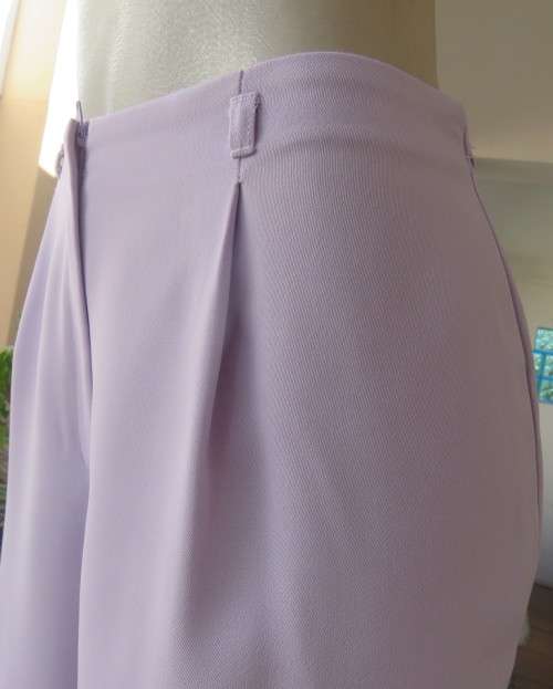 Ankle length lavender textured polyester pants with front pleats. Size 38/14 by FOSHINI. As new.
