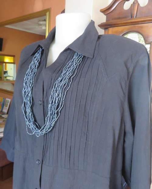 Pretty black cotton button down top with beautiful tucking on front.Band in waist.Size 46.New cond.