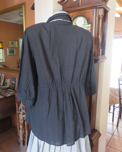 Pretty black cotton button down top with beautiful tucking on front.Band in waist.Size 46.New cond.