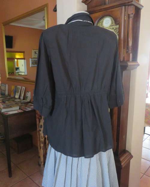 Pretty black cotton button down top with beautiful tucking on front.Band in waist.Size 46.New cond.