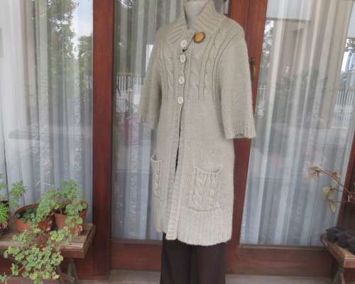 Warm,cosy oyster colour under knee length acrylic knit jacket.High collar.Size 40/16.Cable knit.