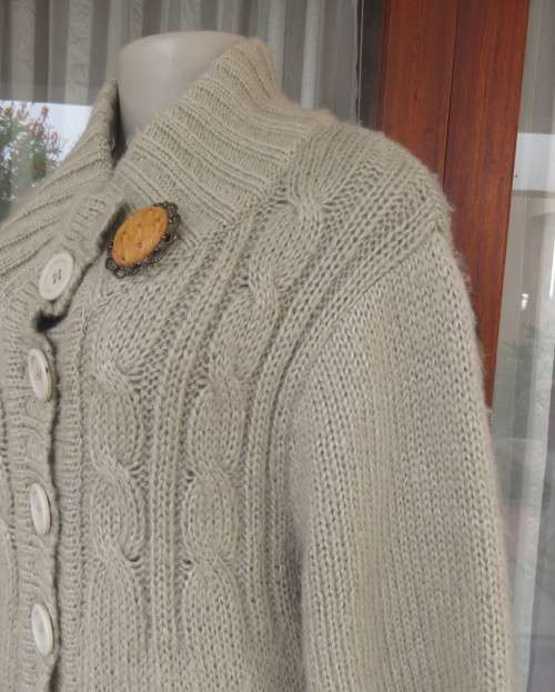 Warm,cosy oyster colour under knee length acrylic knit jacket.High collar.Size 40/16.Cable knit.