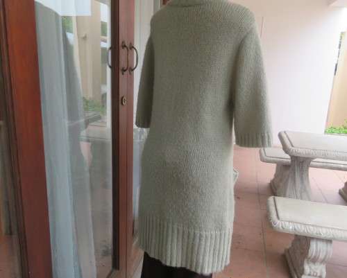 Warm,cosy oyster colour under knee length acrylic knit jacket.High collar.Size 40/16.Cable knit.