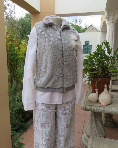 Warm,cozy silver grey fluffy polyester zip-up lined waistcoat.High neckline.Size 36 to 38.As new