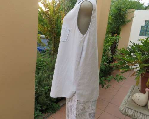 Cool pale blue sleeveless bubble cotton top with button down front.Size 40 to 42.Two cute pockets.