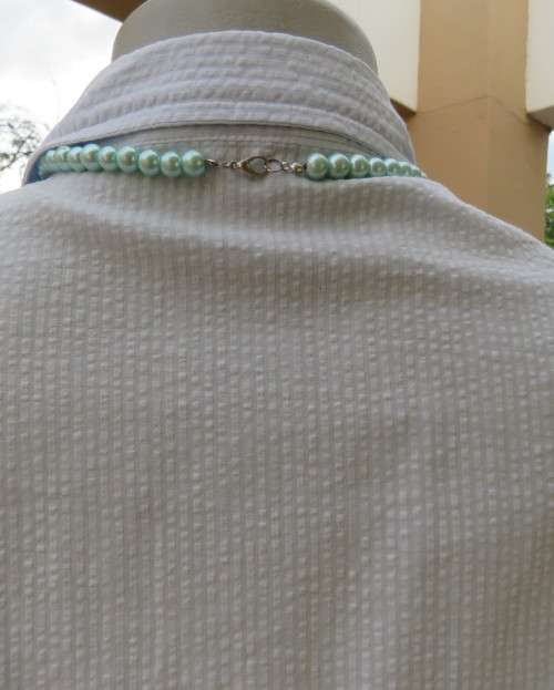 Cool pale blue sleeveless bubble cotton top with button down front.Size 40 to 42.Two cute pockets.
