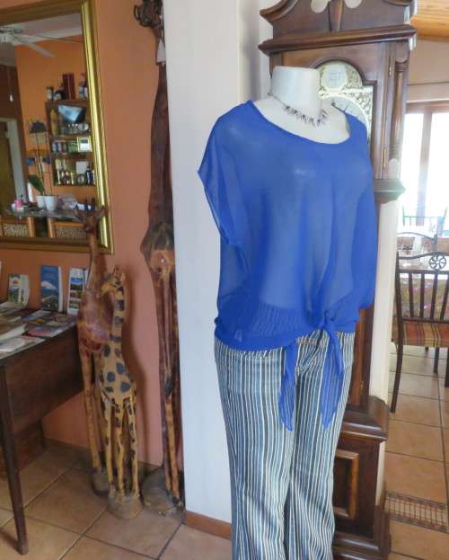 Chic little royal blue sheer polyester slip over top with cut-on sleeves.Size 36/38.By KINGS BABY.