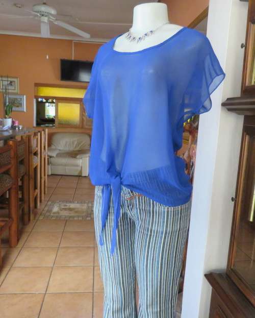 Chic little royal blue sheer polyester slip over top with cut-on sleeves.Size 36/38.By KINGS BABY.
