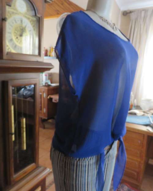Chic little royal blue sheer polyester slip over top with cut-on sleeves.Size 36/38.By KINGS BABY.