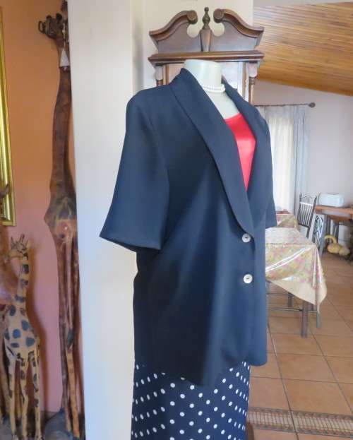Stunning navy short sleeve 2 button closure polyester jacket. Size 38/14 by JADE. New condition.