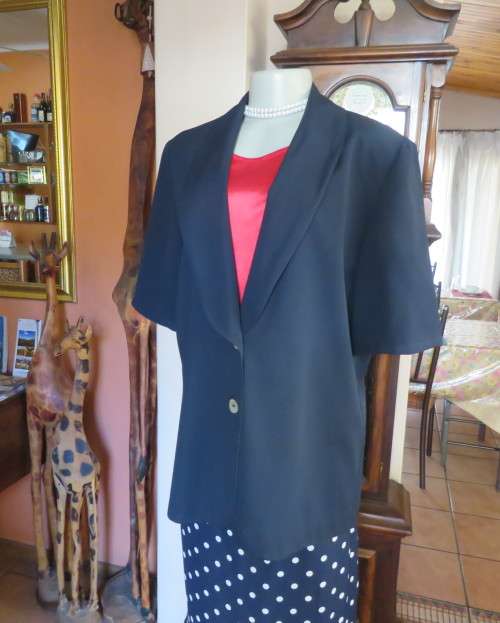 Stunning navy short sleeve 2 button closure polyester jacket. Size 38/14 by JADE. New condition.