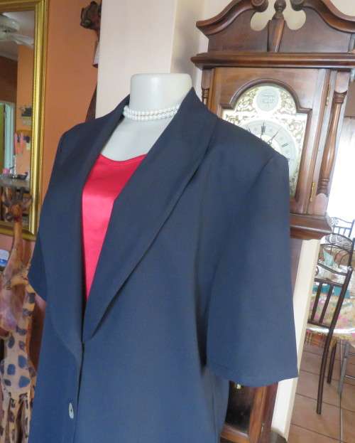 Stunning navy short sleeve 2 button closure polyester jacket. Size 38/14 by JADE. New condition.