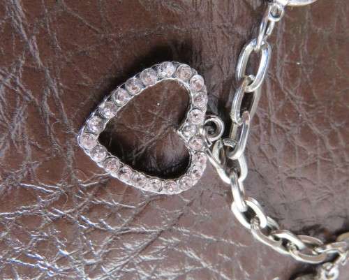 Cute chain bracelet with 3 hearts and 1 small key.With pinkish stones. Length 18cm.As new.
