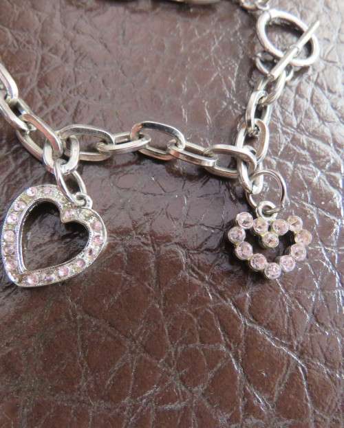 Cute chain bracelet with 3 hearts and 1 small key.With pinkish stones. Length 18cm.As new.